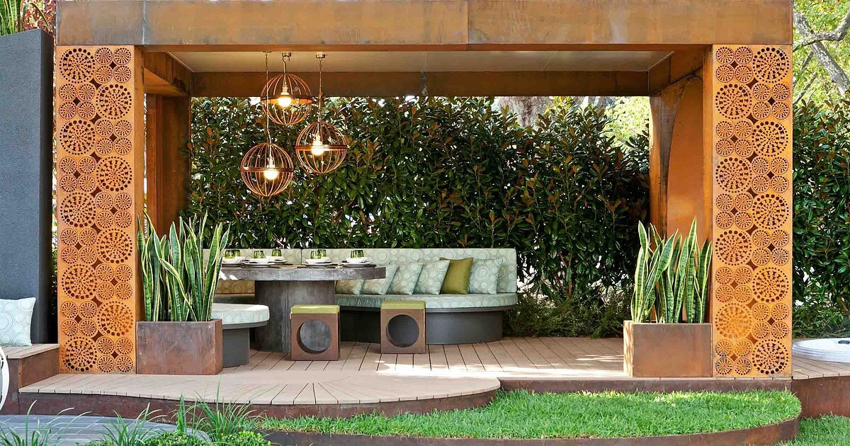 Contemporary timber pavilion with perforated Corten steel screens and pendant lighting at Melbourne show garden
