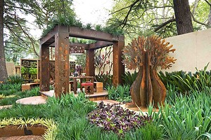 Prefabricated corten steel pavilion with decorative panels and timber decking at Melbourne International Flower Garden Show