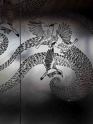 Custom bird light installation on metal doors at St Kilda Gatwick rooftop terrace project