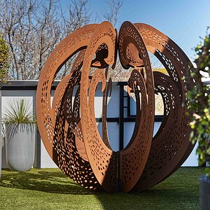 Large perforated corten steel sculptural element on artificial turf rooftop terrace with city views, St Kilda