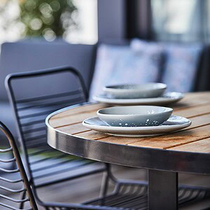 Custom timber dining table with ceramic tableware on St Kilda rooftop terrace from The Block