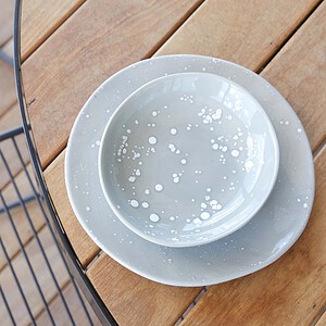 White ceramic bowl and plate with polka dot pattern on timber decking, part of St Kilda rooftop terrace styling