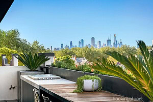 Modern rooftop terrace with blackbutt decking, outdoor kitchen and Melbourne city skyline views from St Kilda penthouse