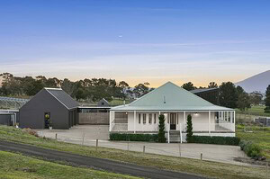 White country home with curved exposed aggregate paths leading to pool area in Gisborne Macedon Ranges landscape