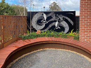 Hendricks House community courtyard in Buninyong by Paal Grant Designs – a moon gate, curved seating and stone paving designed to support gatherings and connection.